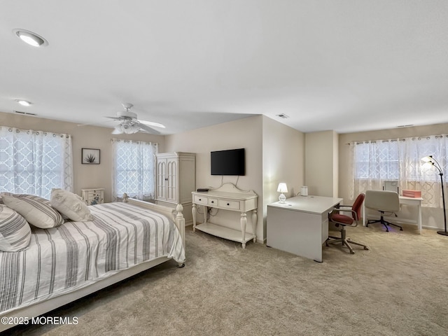 bedroom with light carpet, multiple windows, and ceiling fan