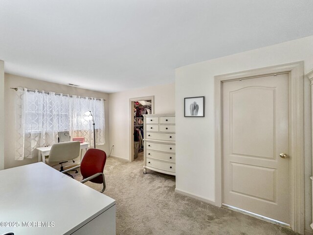 office area featuring visible vents, baseboards, and light colored carpet