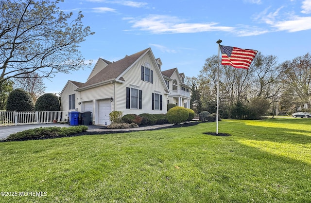 view of side of home with roof with shingles, driveway, a garage, a yard, and fence