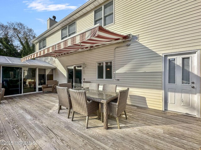 wooden terrace with outdoor dining area