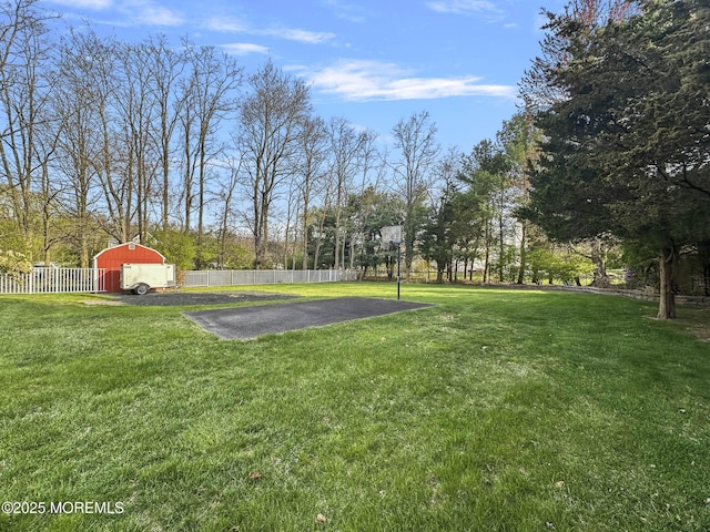 view of yard featuring fence and an outdoor structure