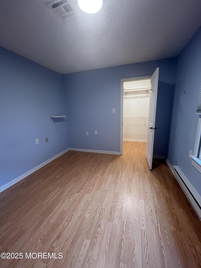 18 Andes Ct, Brick, NJ 08724 - spare room featuring wood finished floors, a baseboard heating unit, and baseboards
