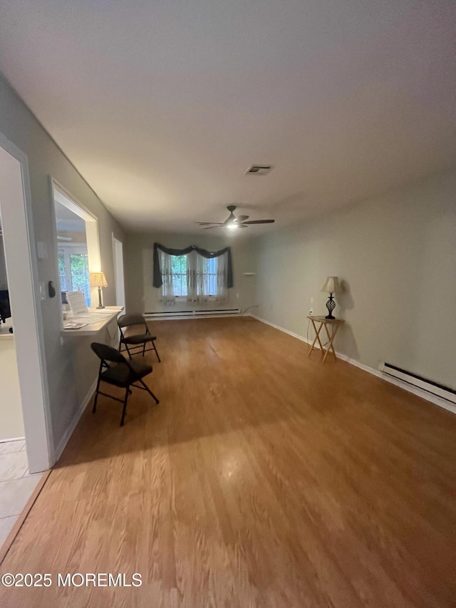 18 Andes Ct, Brick, NJ 08724 - unfurnished living room featuring a baseboard heating unit, ceiling fan, wood finished floors, and baseboards