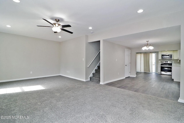 950 Bay Ave, Toms River, NJ 08753 - unfurnished living room featuring baseboards, dark carpet, stairway, recessed lighting, and ceiling fan with notable chandelier