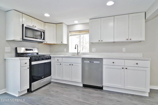 950 Bay Ave, Toms River, NJ 08753 - kitchen with stainless steel appliances, white cabinets, and a sink