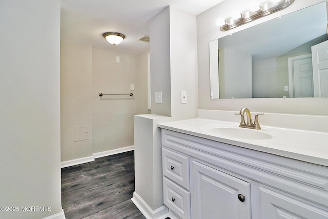 950 Bay Ave, Toms River, NJ 08753 - bathroom with wood finished floors, vanity, baseboards, and visible vents