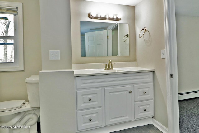 950 Bay Ave, Toms River, NJ 08753 - half bath with vanity, a baseboard heating unit, baseboards, and toilet