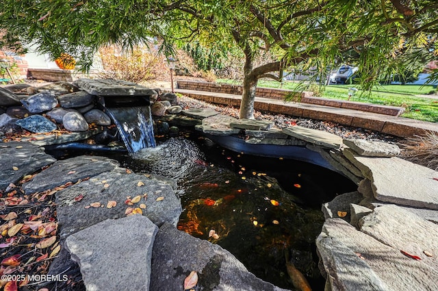 exterior details featuring a small pond