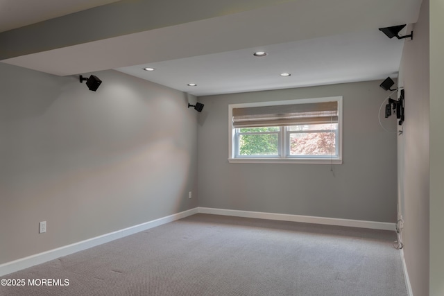 carpeted spare room featuring recessed lighting and baseboards