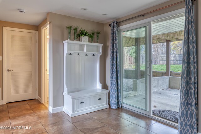 mudroom with baseboards and light tile patterned flooring