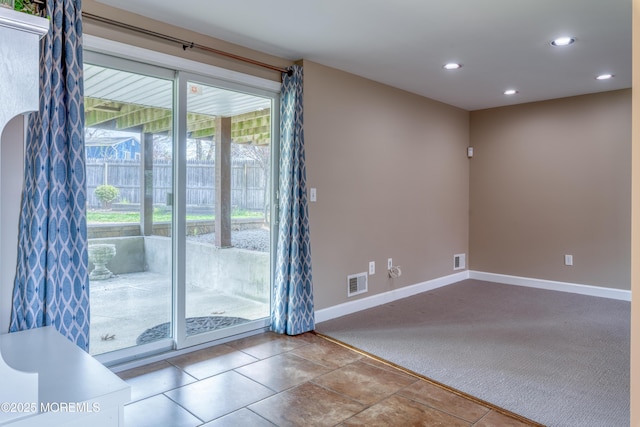 carpeted empty room featuring recessed lighting, visible vents, tile patterned floors, and baseboards