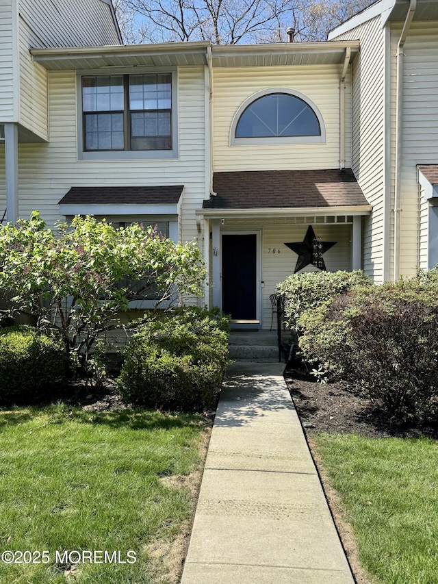 doorway to property with a lawn