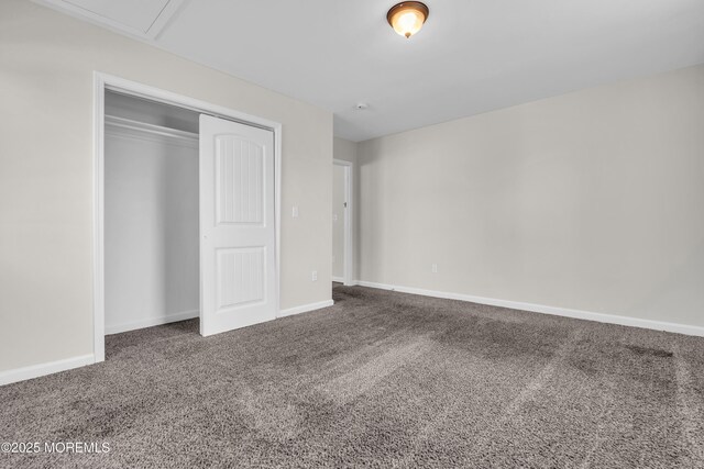 unfurnished bedroom with a closet, carpet flooring, and baseboards