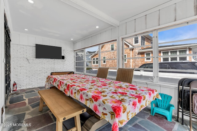 bedroom featuring brick wall, stone floors, and recessed lighting