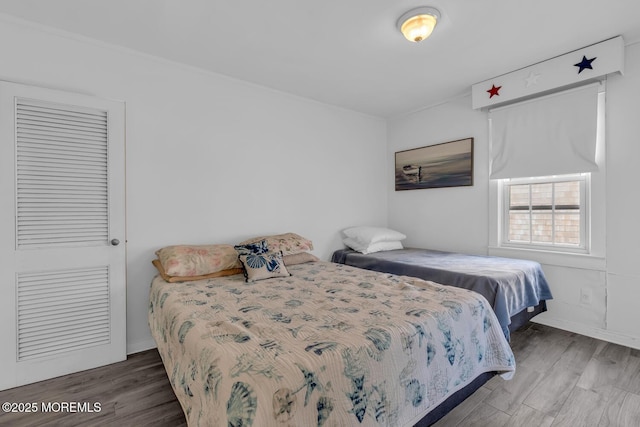 bedroom with wood finished floors and baseboards