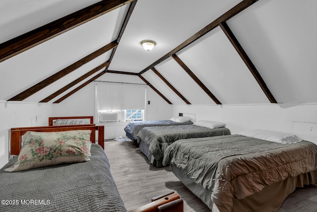 bedroom with wood finished floors, lofted ceiling, and cooling unit