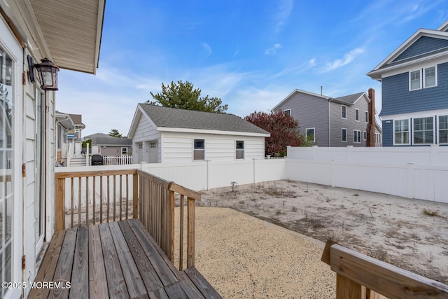 view of yard with an outdoor structure, a residential view, a fenced backyard, and a deck