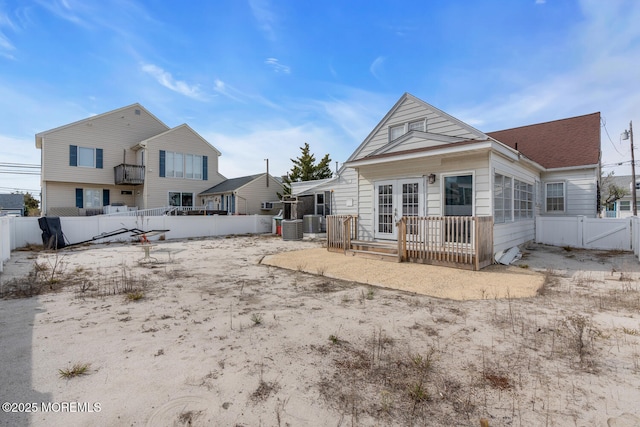 back of house featuring a fenced backyard, french doors, central air condition unit, and a gate
