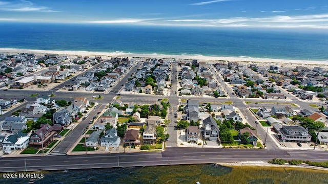 bird's eye view featuring a view of the beach and a water view
