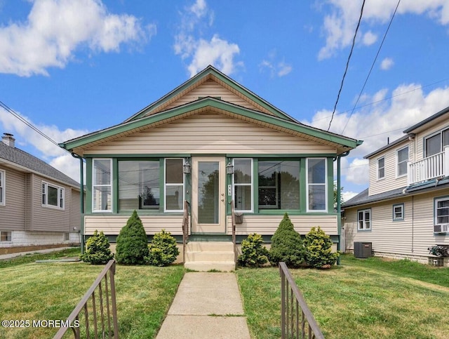 view of front of property featuring central AC and a front lawn