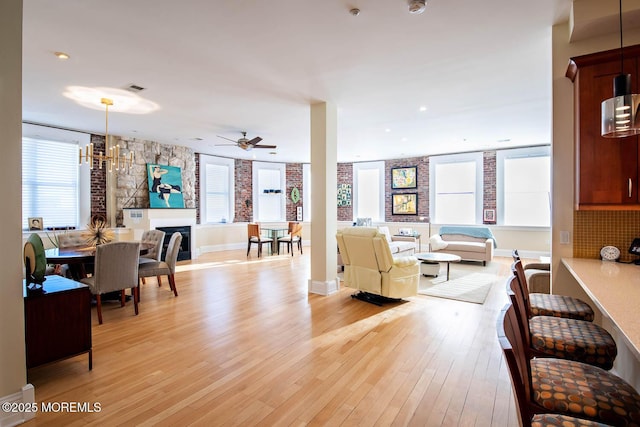 living room with light wood-style flooring and ceiling fan