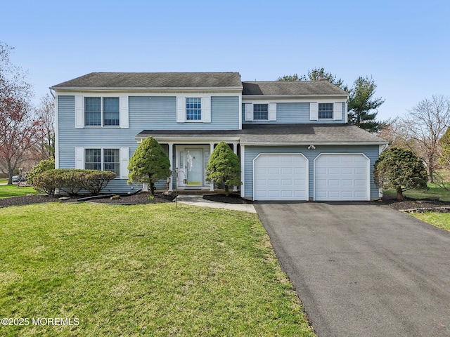 view of front facade with a front yard, driveway, and an attached garage