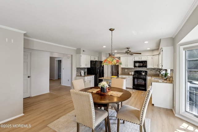 dining area featuring baseboards, light wood-type flooring, ornamental molding, recessed lighting, and ceiling fan
