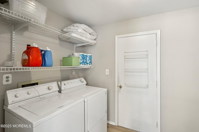 laundry room featuring washing machine and clothes dryer and laundry area