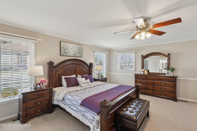 bedroom featuring crown molding, baseboards, ceiling fan, and light carpet