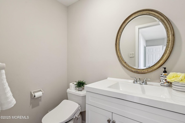 half bathroom with toilet and vanity