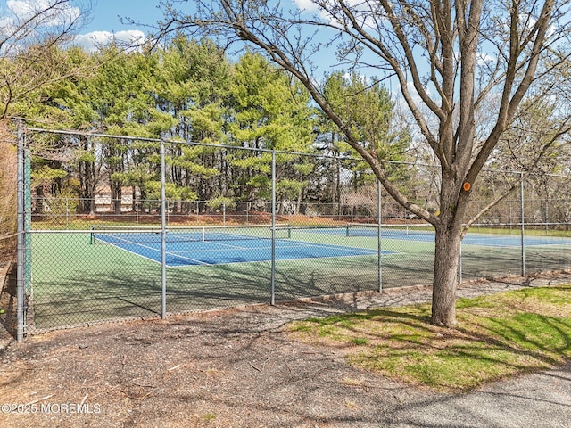 view of sport court featuring fence