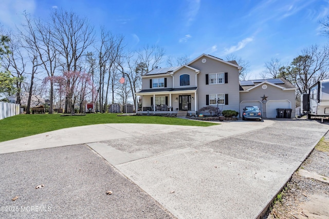 view of front facade with a porch, solar panels, concrete driveway, and a front lawn