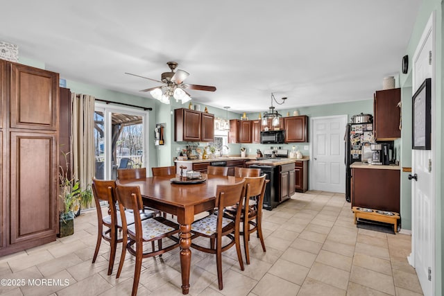 dining space featuring ceiling fan and light tile patterned floors