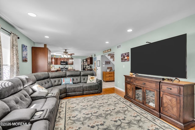 living room featuring recessed lighting, light wood finished floors, visible vents, and ceiling fan