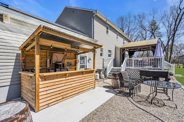 back of house featuring a patio area and a deck