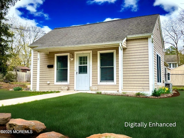 5 Laurel Ave, Toms River, NJ 08753 - view of front of home with a front lawn, fence, and roof with shingles