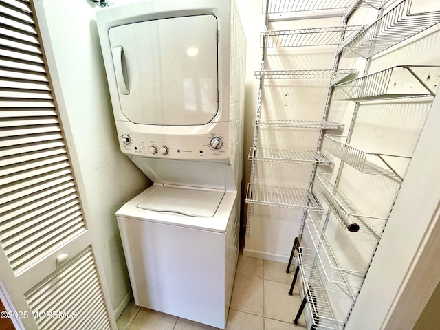 5 Laurel Ave, Toms River, NJ 08753 - laundry area featuring light tile patterned floors, stacked washer and dryer, baseboards, and laundry area
