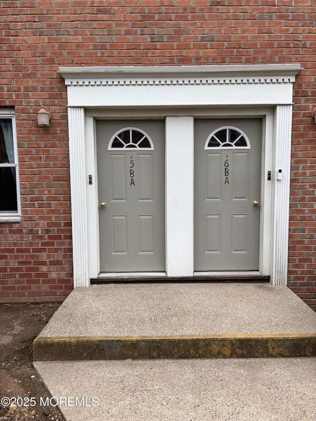 entrance to property with brick siding