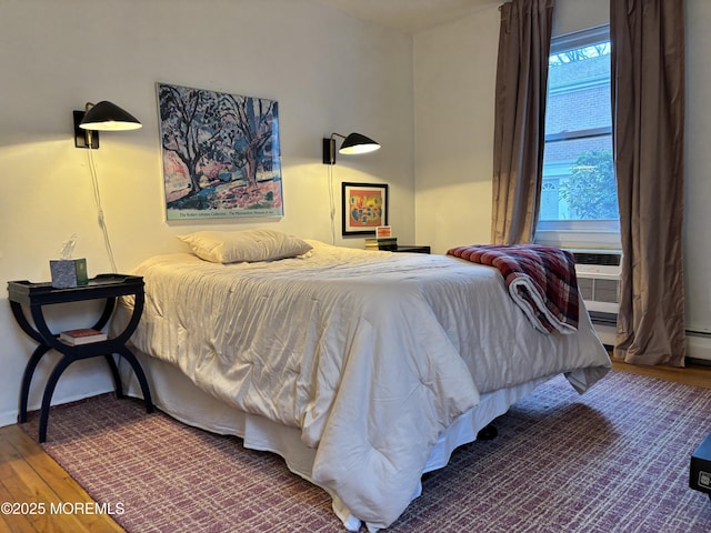 bedroom featuring wood finished floors and baseboards