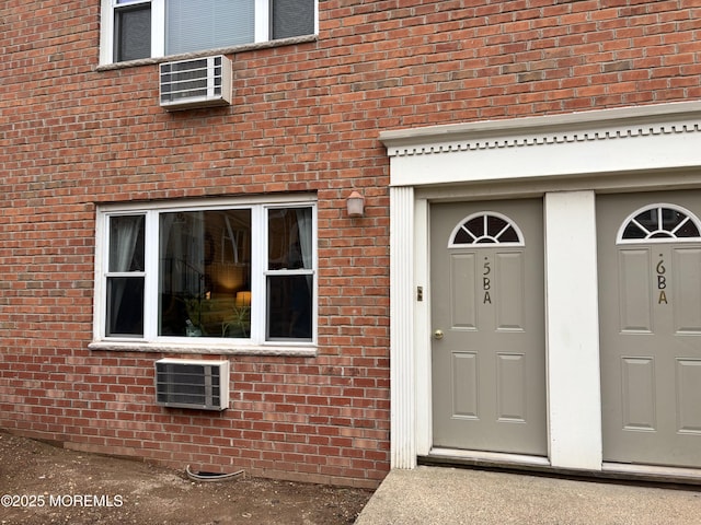 entrance to property featuring brick siding