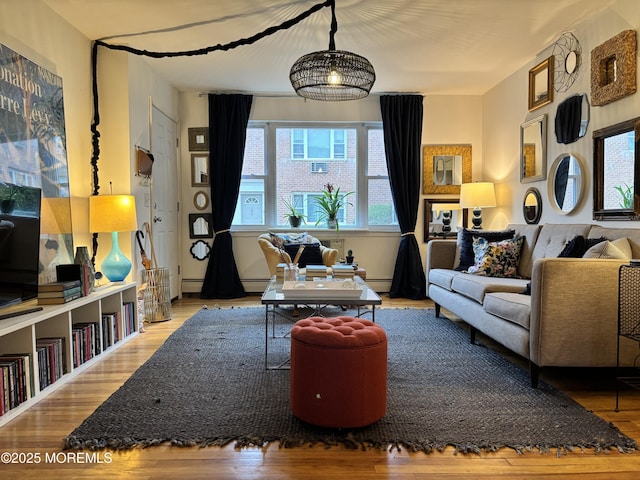 sitting room featuring a baseboard radiator and wood finished floors
