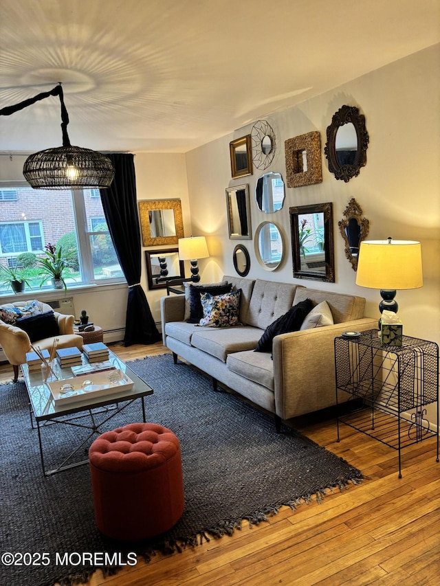 living area featuring wood-type flooring and a baseboard radiator