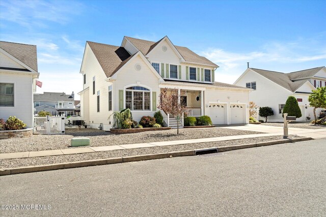 1306 Wickford Ln, Lanoka Harbor, NJ 08734 - traditional-style home featuring a gate, driveway, an attached garage, a porch, and fence
