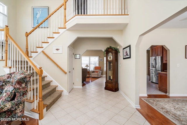 1306 Wickford Ln, Lanoka Harbor, NJ 08734 - foyer entrance featuring a towering ceiling, baseboards, stairway, light tile patterned floors, and arched walkways