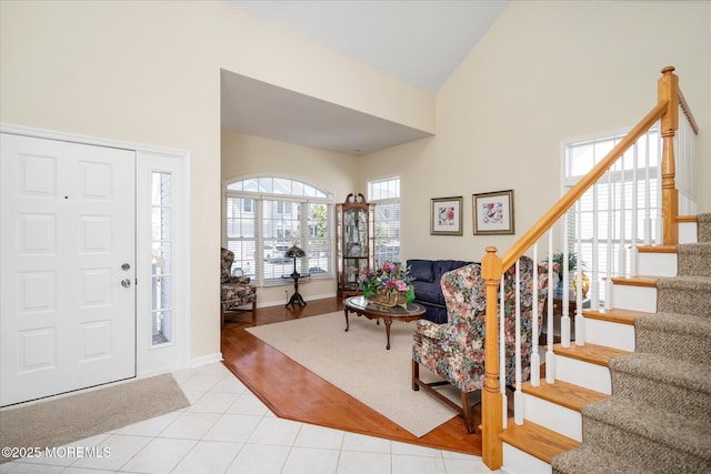 1306 Wickford Ln, Lanoka Harbor, NJ 08734 - foyer entrance with high vaulted ceiling, stairs, baseboards, and light tile patterned flooring