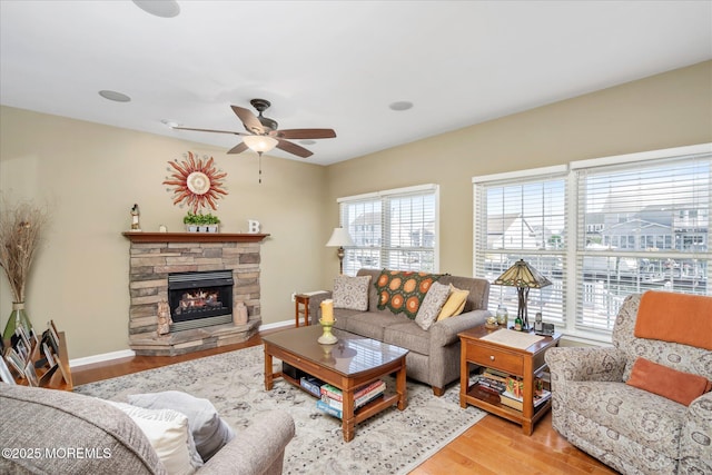 1306 Wickford Ln, Lanoka Harbor, NJ 08734 - living area featuring a wealth of natural light, a fireplace, a ceiling fan, and wood finished floors