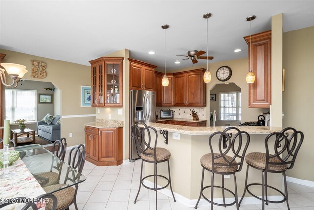 1306 Wickford Ln, Lanoka Harbor, NJ 08734 - kitchen with a wealth of natural light, a peninsula, ceiling fan, and stainless steel fridge