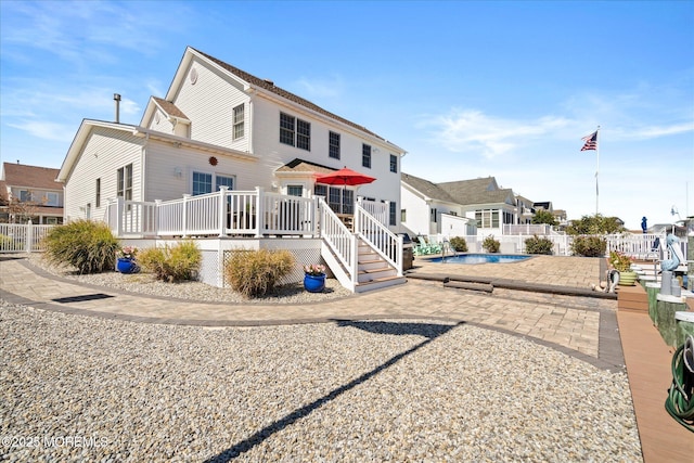 1306 Wickford Ln, Lanoka Harbor, NJ 08734 - view of front of property featuring a deck, a patio area, fence, a fenced in pool, and a residential view