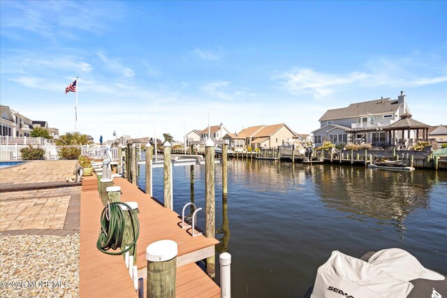 1306 Wickford Ln, Lanoka Harbor, NJ 08734 - dock area with boat lift, fence, a residential view, and a water view