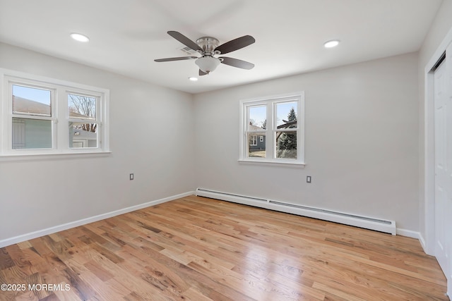empty room featuring baseboards, recessed lighting, light wood-style floors, ceiling fan, and a baseboard radiator